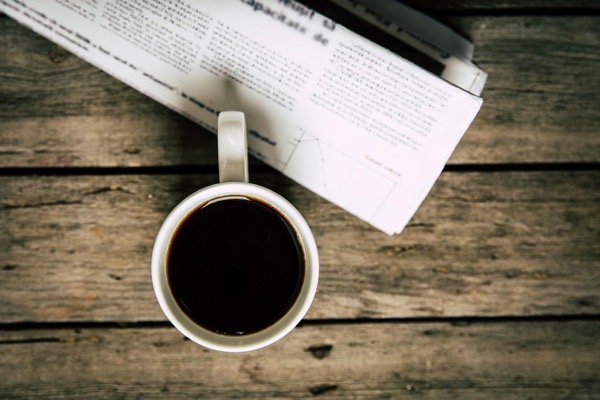 Cup of coffee and newspaper