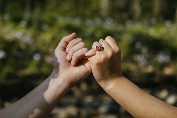 Two hands joined in a pinky promised. Photo by Olivia anne snyder wT_BwKOeEik unsplash.