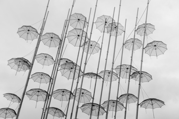 Ronit shaked  ENNtoNUxhU unsplash. Transparent umbrellas appear to float in the sky.