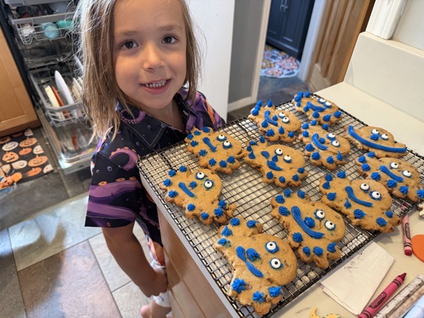 IMG_4727.jpeg A young boy looking over a tray of cookies decorated as octopuses